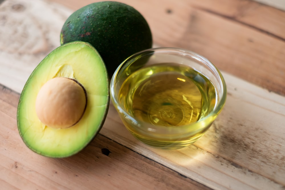 Avocado And Avocado Oil On A Wooden Background